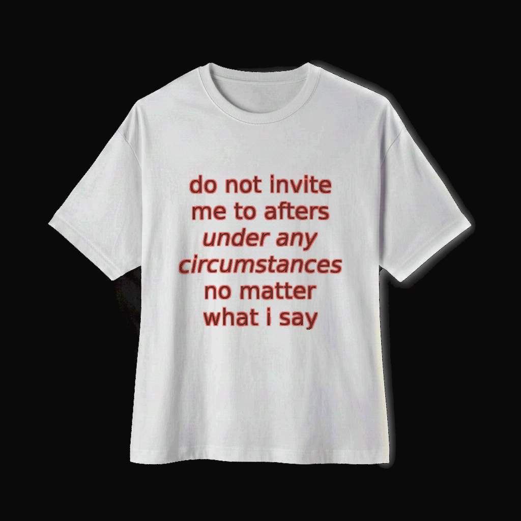 White oversized boxy tee shown from an alternate angle on a near-black backdrop, coral italic print