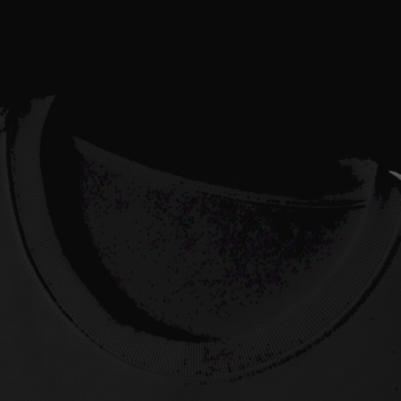 Close-up of the ribbed crew collar and shoulder seam on the black oversized boxy tee